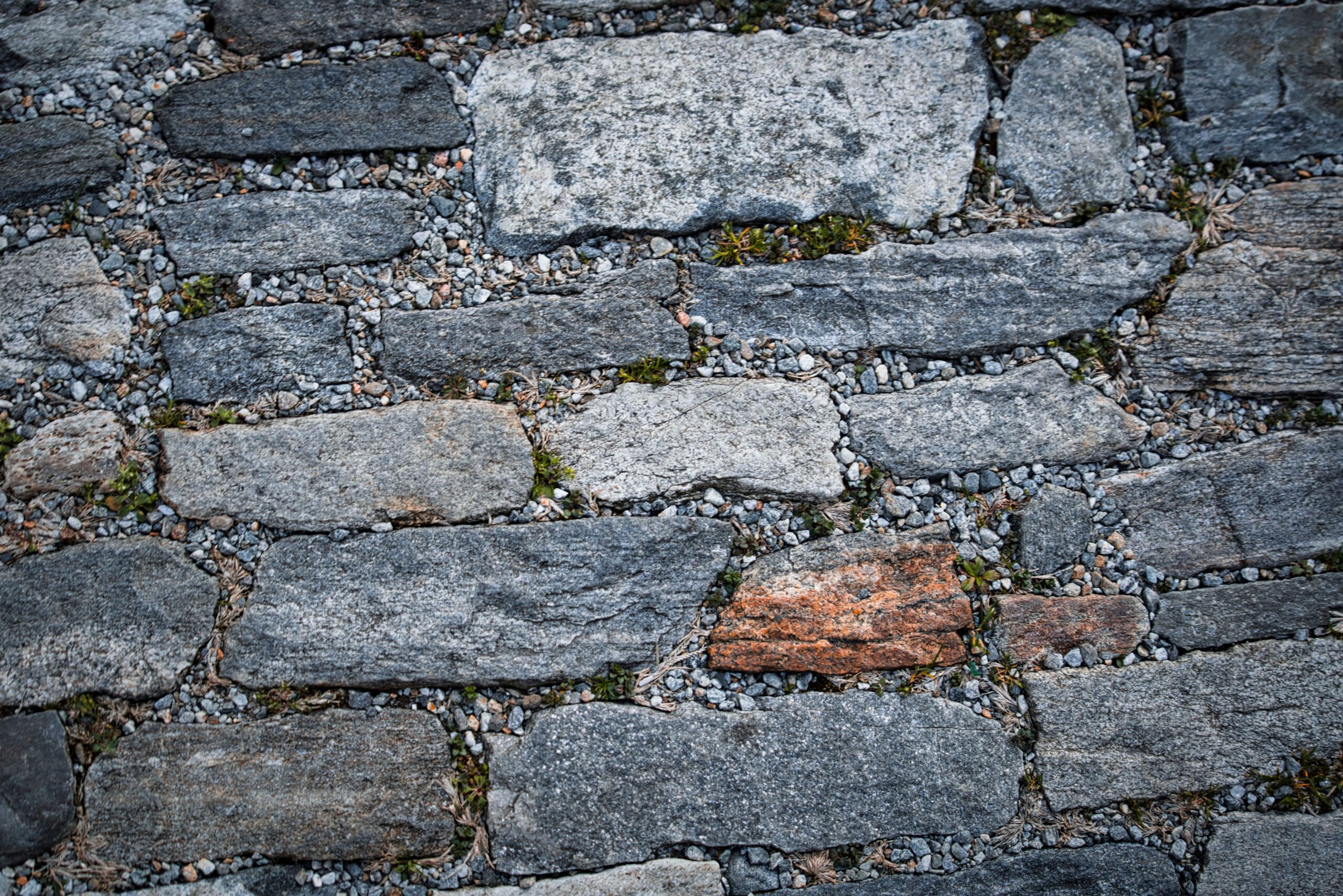 Close-up of weathered stone pavement showcasing textured natural rock formations and earthy tones.